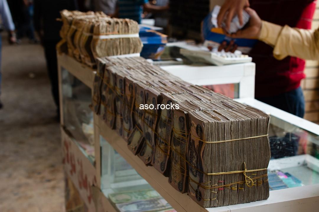 Stacks of banknotes lined up on a currency exchange counter, illustrating the dollar to naira parallel market